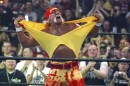 FILE - in this April 3, 2005, file photo, Hulk Hogan fires up the crowd, ripping his yellow tank off between matches during WrestleMania 21 in Los Angeles.