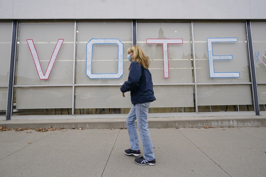 A local resident arrives to cast her ballot during early voting for the general election on Oct. 20 in Adel, Iowa. A new analysis by NPR, the Center for Public Integrity and Stateline reveals that since 2016, 261 polling places in the state have been closed, most due to COVID-19.