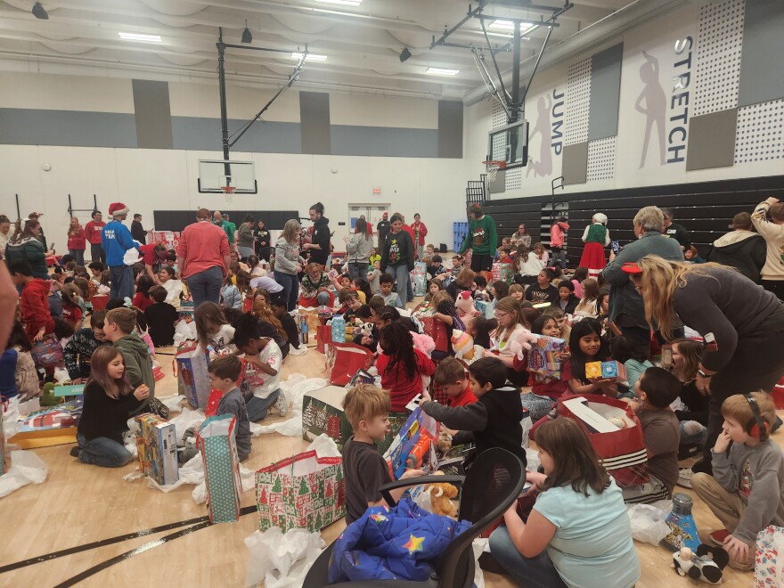 Students at York Elementary in Springfield, Mo. open gifts given to them by James River Assembly on December 12, 2025.