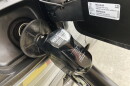 A fuel pump nozzle is seen at a gas station in Mundelein, Ill., Tuesday, Feb. 14, 2023.