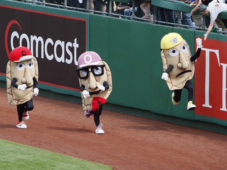 The Pittsburgh Pirates Pierogies — Sauerkraut Saul (from left), Oliver Onion and Cheese Chester — compete in a footrace around the outfield warning track following the end of the fifth inning of a game between the Pittsburgh Pirates and the Milwaukee Brewers in Pittsburgh.