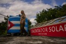Felix Jose Morfi stands by his solar-powered water heater system he set up on his home's roof in Regla, Havana province, Cuba, Thursday. Jan. 29, 2026. (AP Photo/Ramon Espinosa)