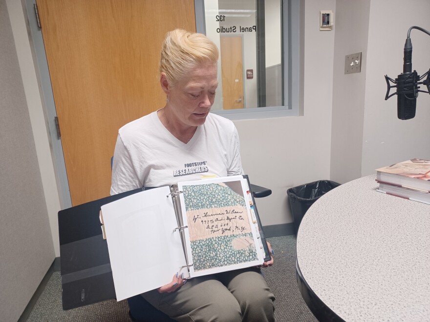 Kathryn Vicat with Footsteps Researchers holds a binder she compiled with information about Native Americans who fought in WW II and whose names were embroidered on a quilt (photo taken in July, 2024).