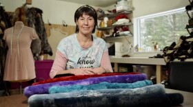 Artist Christy Ruby sits for a picture with her colored sea otter in her studio on March 2, 2023.