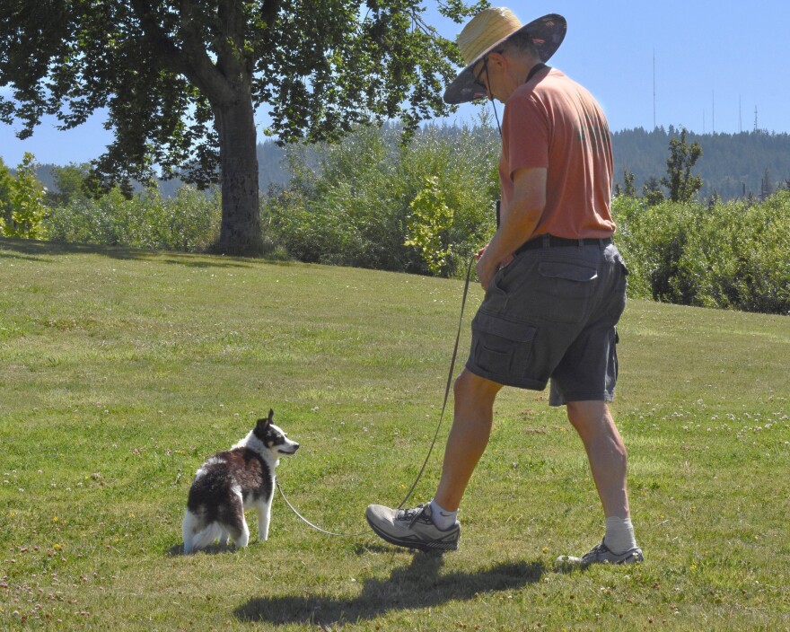 A dog owner walks their pet at Amazon Park, July 25, 2025.