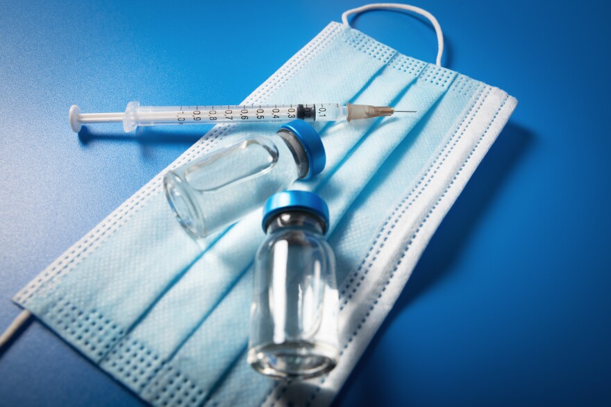 A mask, vaccine and a syringe