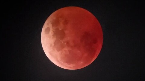 the moon with a reddish hue during a lunar eclipse