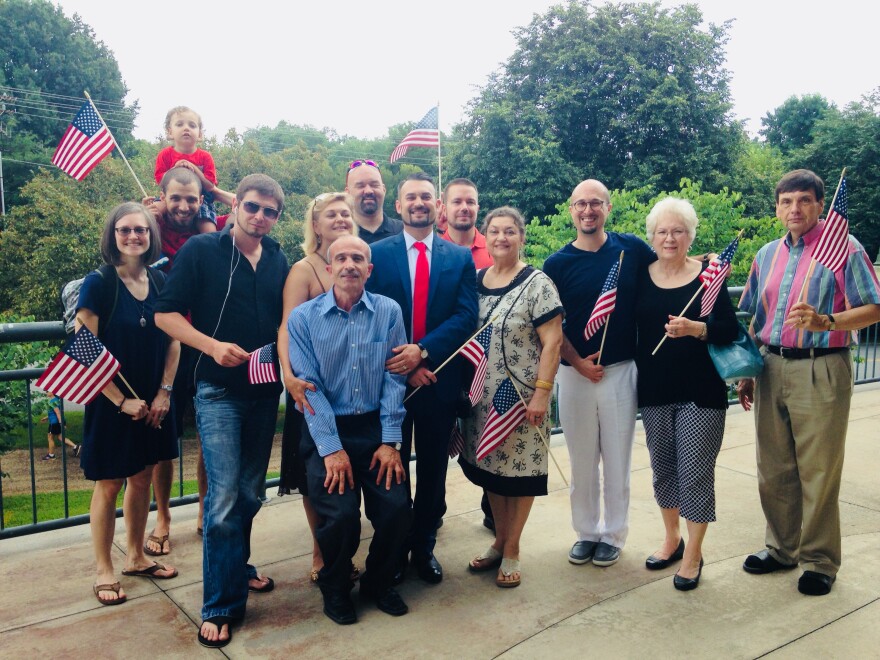 Anton Moussaev, center, stands with family and friends after his naturalization ceremony in 2017. 