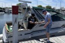 Bill Parilo (left) paying Mark Conley (right) in cash for fuel.