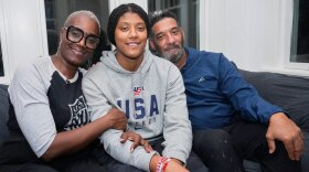 Laila Edwards, center, the first Black woman to suit up for Team USA women's Olympic hockey, poses for a photo with her parents, Charone Gray-Edwards, left, and Robert Edwards, right, in her childhood home in Cleveland Heights, Ohio, Wednesday, Nov. 5, 2025. 