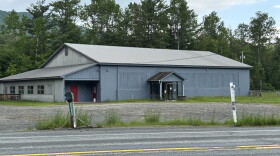 A gray building by a road