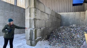 Lindsey Walker, head of recycling outreach and market development for Emmet County's recycling program, points to a pile of crushed glass that will later be picked up and taken to Ohio. From there, it's cleaned and recycled into fiberglass insulation and other products. (Photo: Ellie Katz/IPR News)