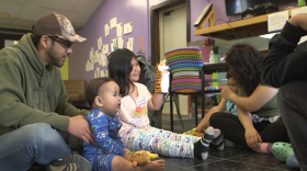 A man with a newborn and other children.