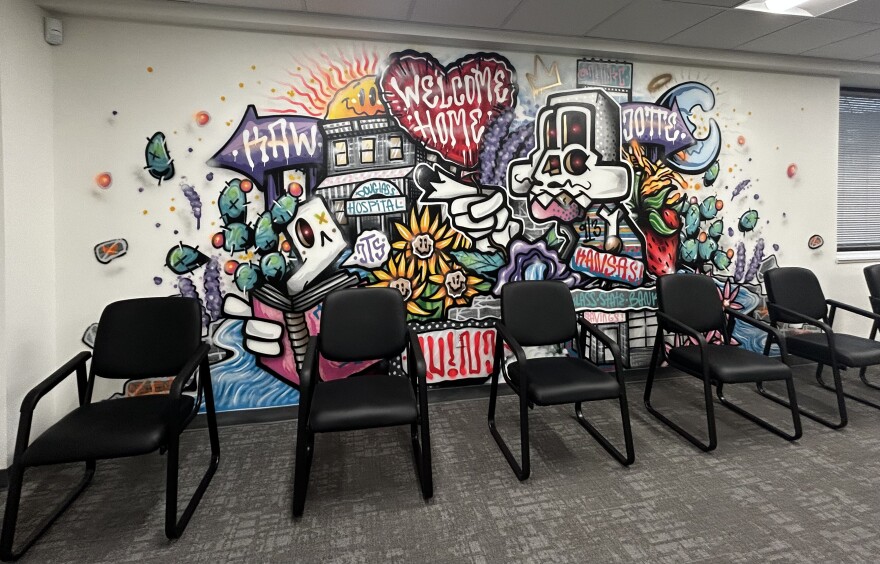 A series of murals painted by local artists greet people as they walk in, part of an effort to create a warm, welcoming environment.