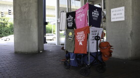 A vendor set up a merchandise booth under U.S. Bank Arena at Broadway and Pete Rose Way on Wednesday afternoon.