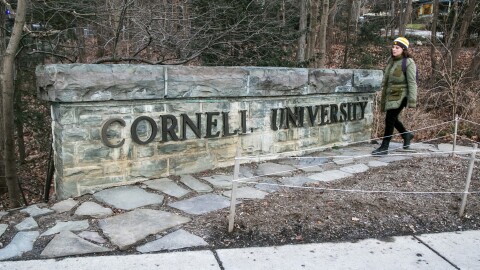 FILE - A woman walks by a Cornell University sign on the Ivy League school's campus in Ithaca, New York, on Jan. 14, 2022. The Cornell University student accused of making online threats against Jewish people on campus had mental health struggles and apparently showed remorse soon after, according to his mother, Monday, Nov. 6, 2023.(AP Photo/Ted Shaffrey, File)