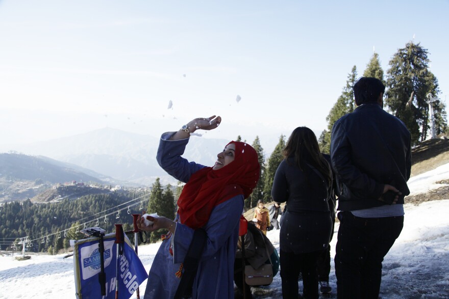 At a Swat Valley ski resort, a woman dodges snowballs. Domestic tourism is strong to the Swat Valley, although residents have struggled to revive their international tourism market.