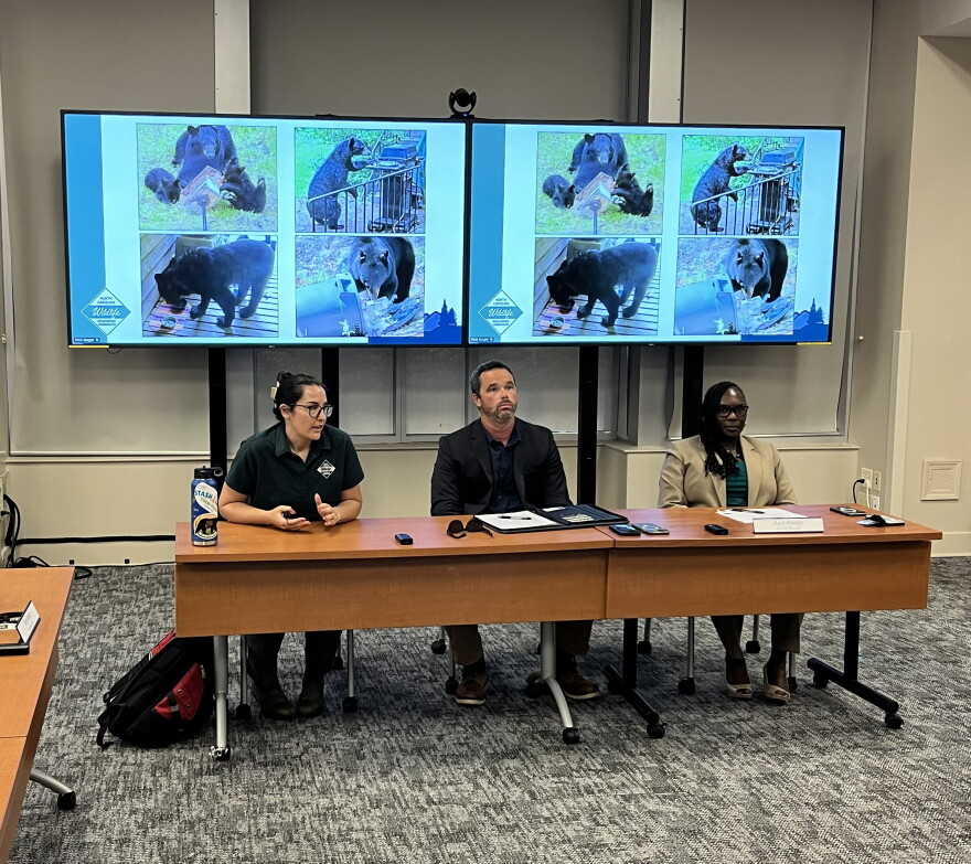 Ashley Hobbs, (left) a biologist with the N.C. Wildlife Resources Commission, makes a point about local bear problems during a Sept. 15 briefing for the Buncombe County Board of Commissioners. Also shown are county Solid Waste Director Dane Pederson, center, and County Manager Avril Pinder.