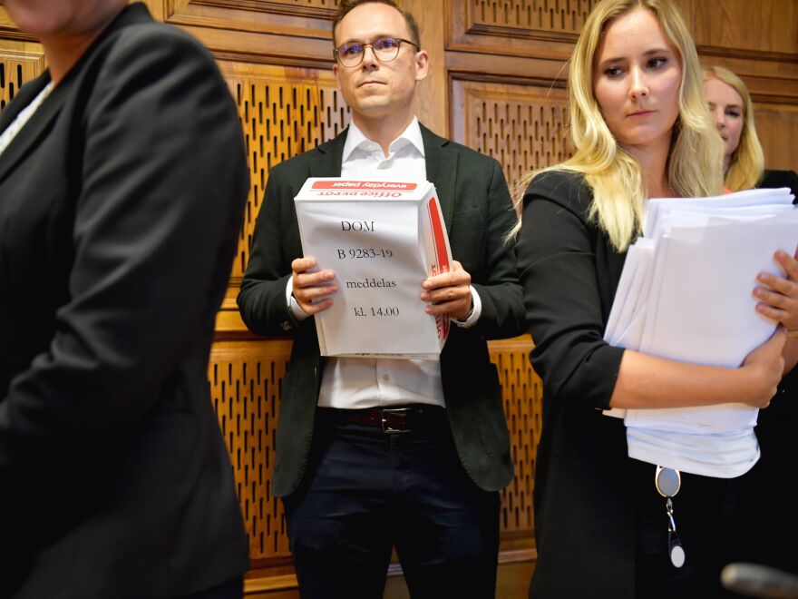 Court staff hand out the verdict to the press at the end of a hearing in US rapper A$AP Rocky's assault trial, in Stockholm, Sweden.