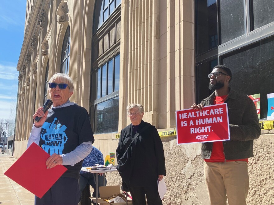 Sue Dinsdale, executive director of Iowa Citizen Action Network, speaks at the Monday rally on the ACA outside Rep. Mariannette Miller-Meeks's office in downtown Davenport.
