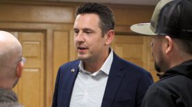 Zach Lahn, a Republican gubernatorial candidate in Iowa, has a significant association with Kansas as co-founder of a Wichita school in 2018 and as a registered voter in the state until 2024. His "Iowa First" platform will be put to a test Tuesday in the primary election. In this image from April 2, 2026, Lahn chats at opening of his West Des Moines campaign headquarters.
