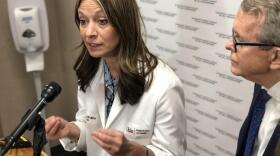 Dr. Amy Acton, with Gov. Mike DeWine alongside, talks to reporters before the statewide coronavirus summit.
