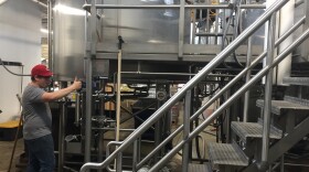 Workers prepare for the next batch of beer at Land Grant Brewing in Columbus.