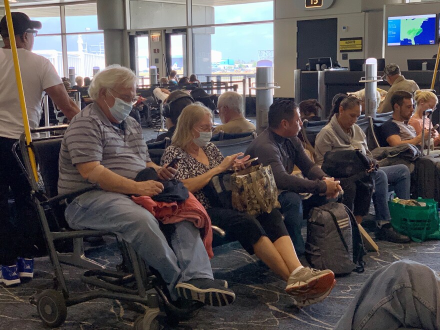 Tampa airport airline passengers with face masks for protect from coronavirus. 