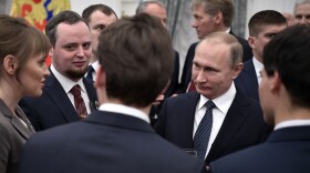 Russian President Vladimir Putin, right, speaks with winners of the 2016 Presidential prize for young scientists after an award ceremony in the Kremlin in Moscow, Russia. (Alexei Nikolsky/AP)