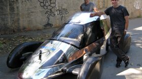 Team Edison2's Oliver Kuttner (left) and Brad Jaeger, one of the team's professional race car drivers, with the Very Light Car that won the mainstream class of the X Prize competition.