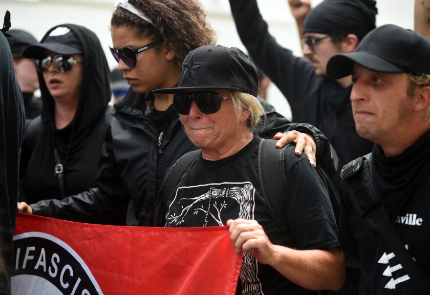 For a moment of remembrance, antifa group marches to the memorial site of last year's tragedy in Charlottesville at the Unite the Right rally.