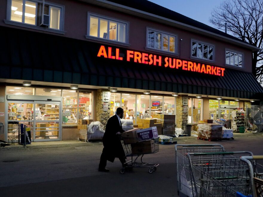 A man walks through the parking lot of a supermarket in New York's Rockland County, which has declared a state of emergency over a measles outbreak.