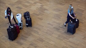 Travelers wearing protective face masks arrive to Ben Gurion Airport near Tel Aviv, Israel on Sunday. Israel on Sunday approved barring entry to foreign nationals as part of its efforts to clamp down on a new coronavirus variant.