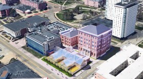 An aerial view of three buildings and a glass greenhouse