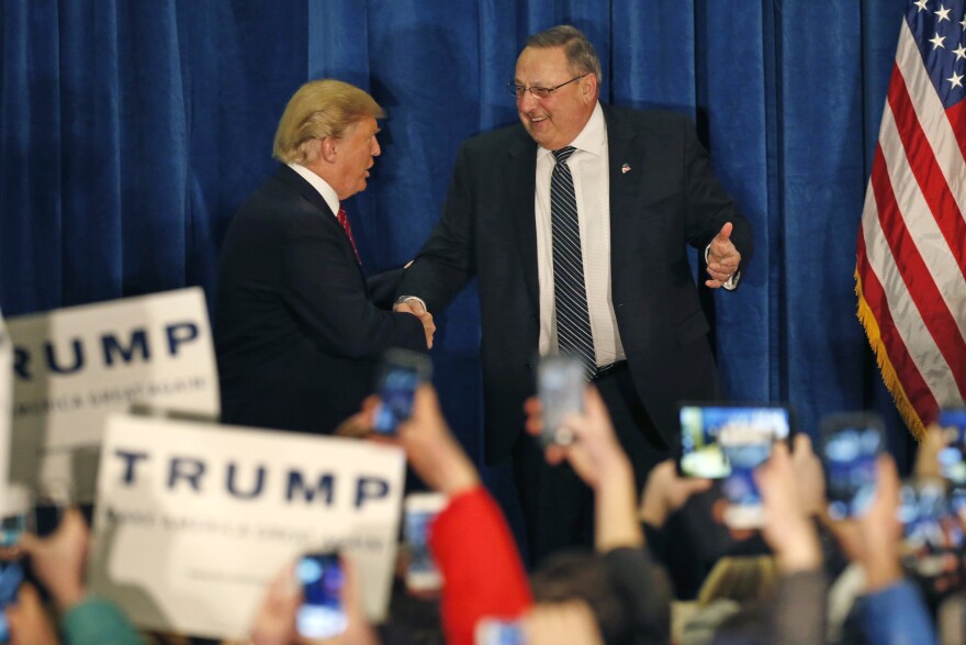 Republican presidential candidate Donald Trump is welcomed to the stage by Maine Gov. Paul LePage at a campaign stop, Thursday, March 3, 2016, in Portland, Maine.