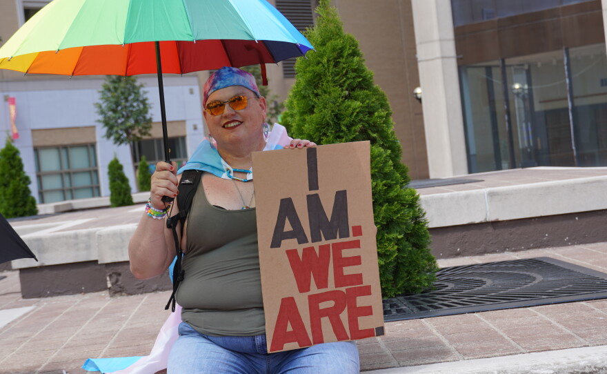 Images of supporters holding signs that they made for the protest.