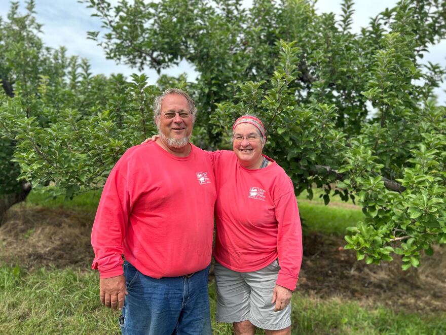 Chuck and Diane Souther stand in front of one of their apple trees on Apple Hill Farm, which was hit hard by a freeze in May that killed most of their crop.