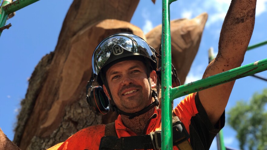 Chad Gainey takes a break from carving on Wednesday afternoon.