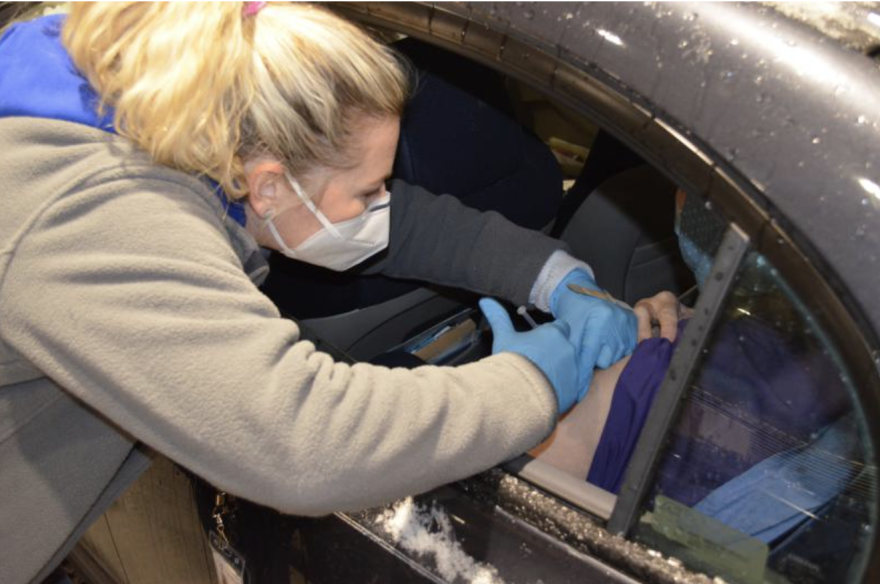 A woman gets a vaccine at drive-through Franklin County clinic