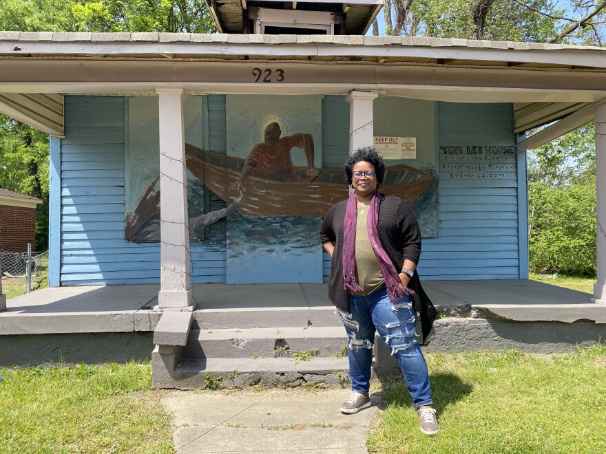 Charmeal Neely, a great-great-niece of Tom Lee stands in front of his former house bought for him by the engineers group whose members he saved from drowning in the Mississippi River in 1925.