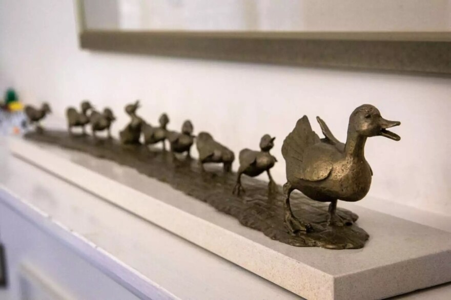A maquette of "Make Way for Ducklings" walks over a fireplace at sculptor Nancy Schön's home.