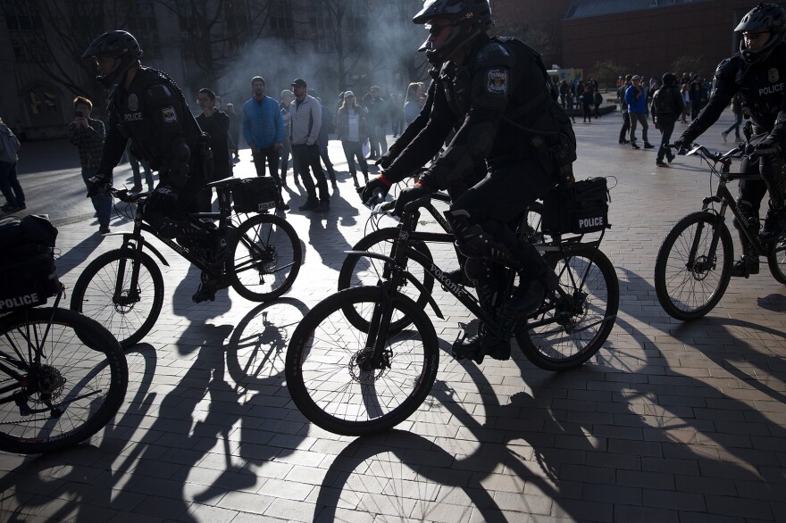 Police officers form a line on Saturday, Feb. 10, 2018, outside of a College Republicans rally at Red Square on the University of Washington campus in Seattle.