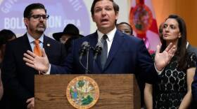 Florida Gov. Ron DeSantis, center, speaks during a bill signing ceremony on May 9 at the William J. Kirlew Junior Academy, in Miami Gardens.