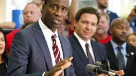 Florida Surgeon General Dr. Joseph Ladapo speaks to supporters and members of the media before a bill signing by Gov. Ron DeSantis, right, Nov. 18, 2021, in Brandon. That week, Ladapo asked the state medical board to draft policies that would likely restrict gender dysphoria treatments for transgender youth.