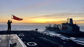 Ashleigh Bishop, 19, a quartermaster from Lynchburg, Virginia, who joined the Navy a year ago, waves a flag at the forward edge of the flight deck to alert a refueling ship of the bow’s position. “Every job on this ship is important," she said.