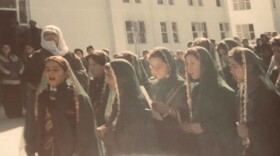 Zarifa Hamidi, center with white paper, in the early 2000s at an orphanage in Afghanistan. (Courtesy)