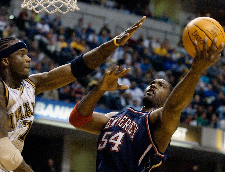 New Jersey Nets forward Rodney Rogers puts up a shot against Indiana Pacers forward Jermaine O'Neal during the first quarter of a basketball game in Indianapolis, April 9, 2004.
