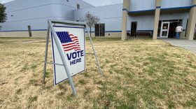 'Vote here" sign outside of a polling station.