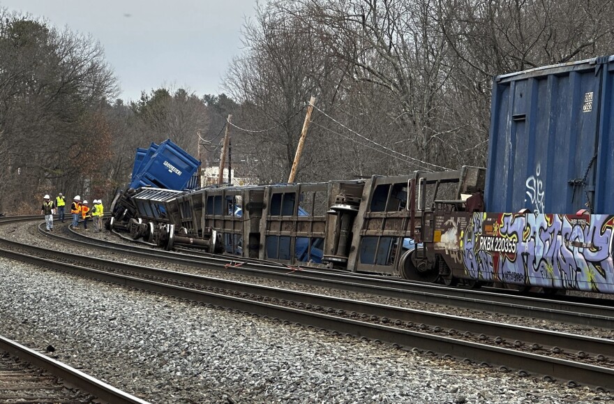 Officials work at the scene of a derailed freight train with no hazardous materials, Thursday, March 23, 2023, in Ayer, Mass.