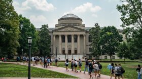People walk on the campus of the University of North Carolina Chapel Hill  in Chapel Hill, North Carolina.